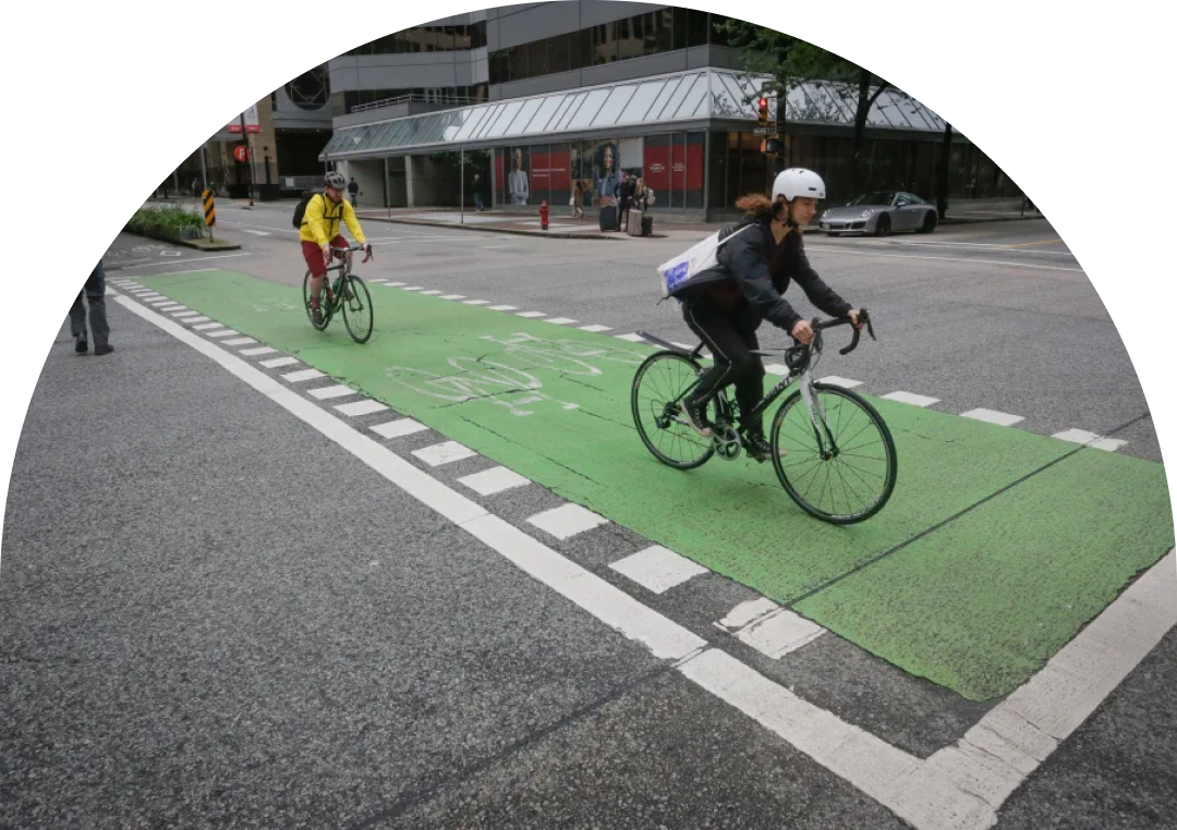 A small green plant with two leaves grows out of a glass jar filled with assorted coins. The background is blurred with soft, natural light, focusing attention on the plant and the jar. 